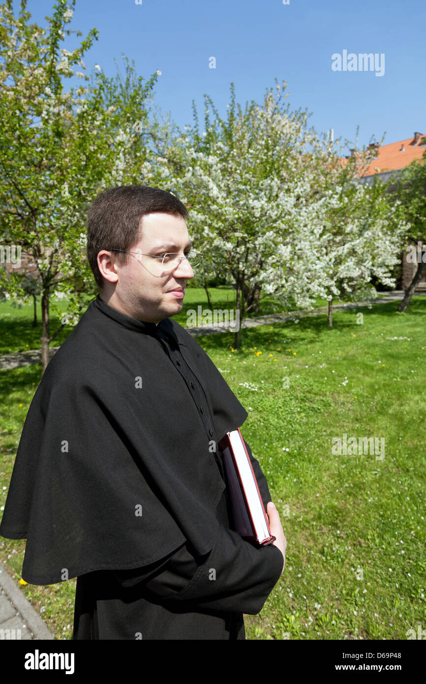 Krakow, Poland, priest in the garden of the monastery of Canons Regular Lateranensischer Congregation Stock Photo