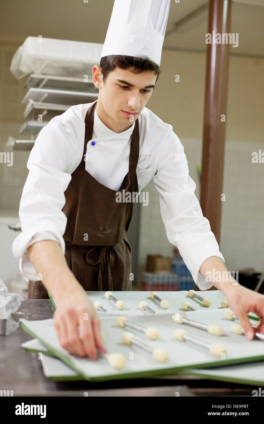 Baker making cookies in kitchen Stock Photo
