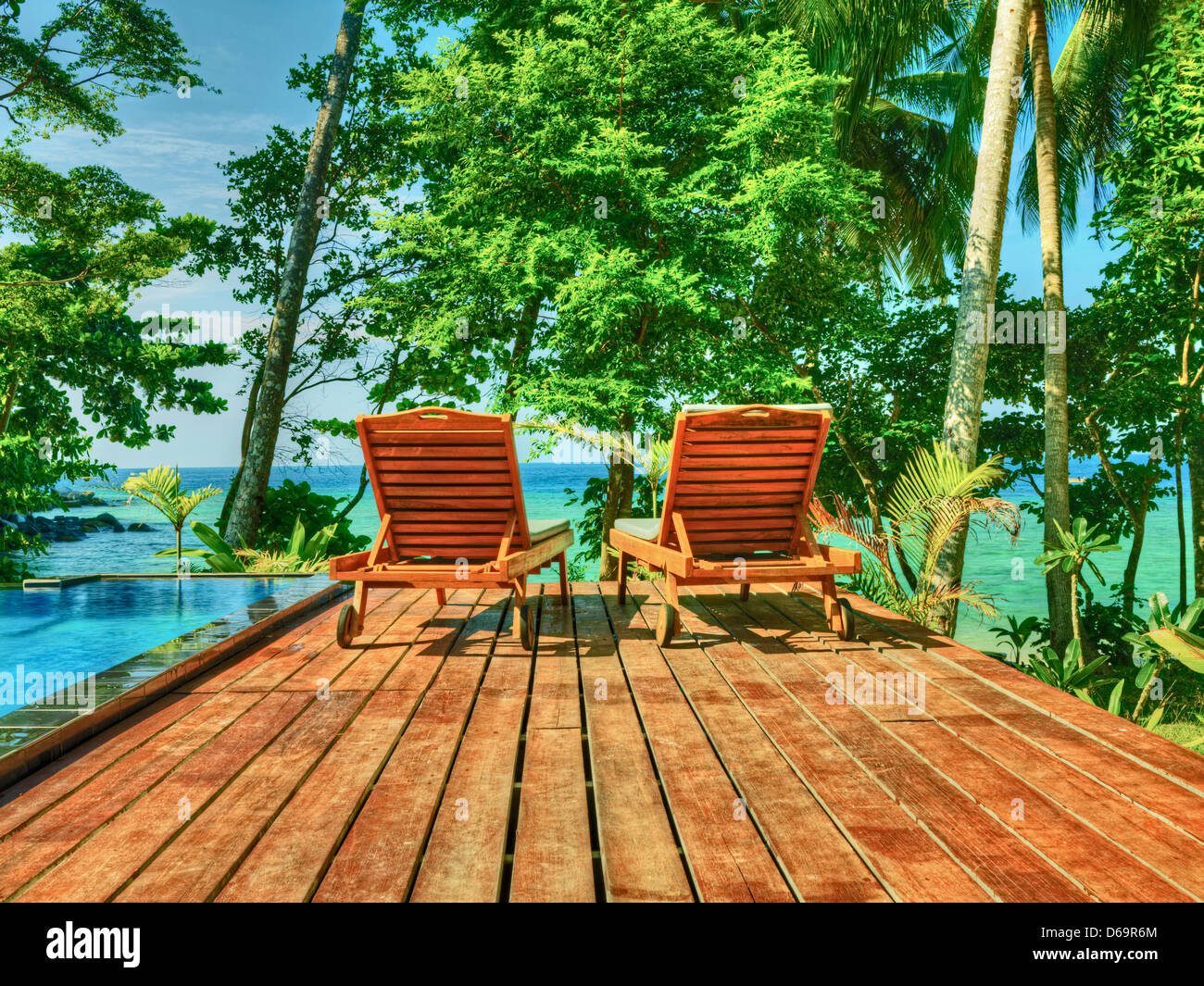 Lawn chairs overlooking tropical beach Stock Photo Alamy