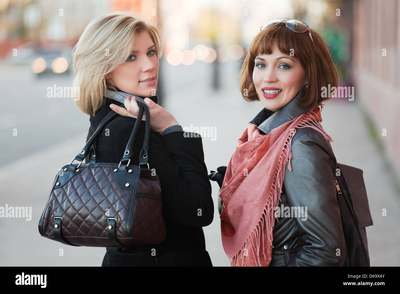 Two young women on a city street Stock Photo - Alamy