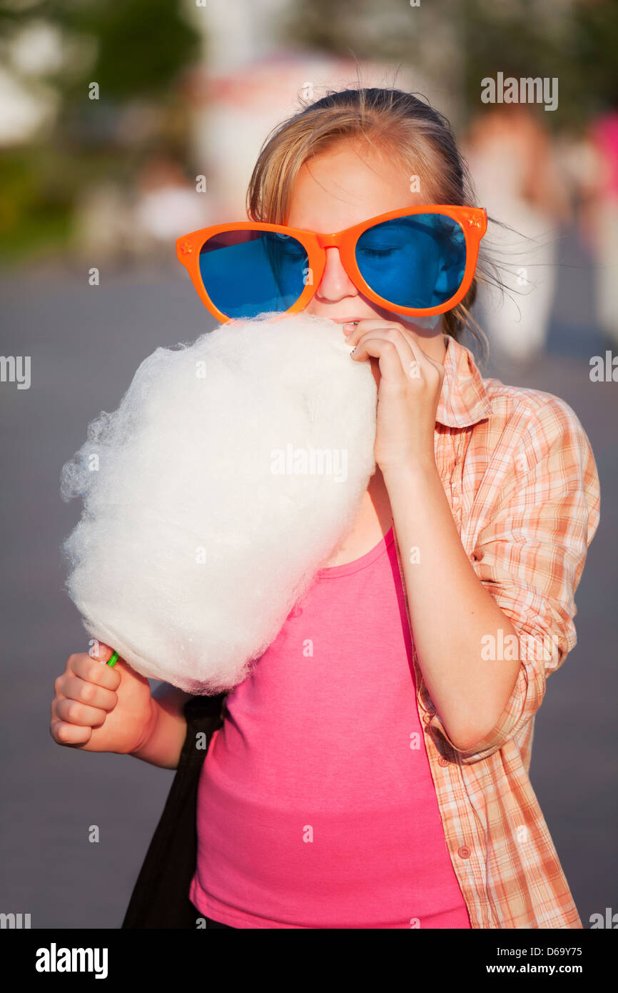 Girl Eating Cotton Candy Stock Photo - Alamy