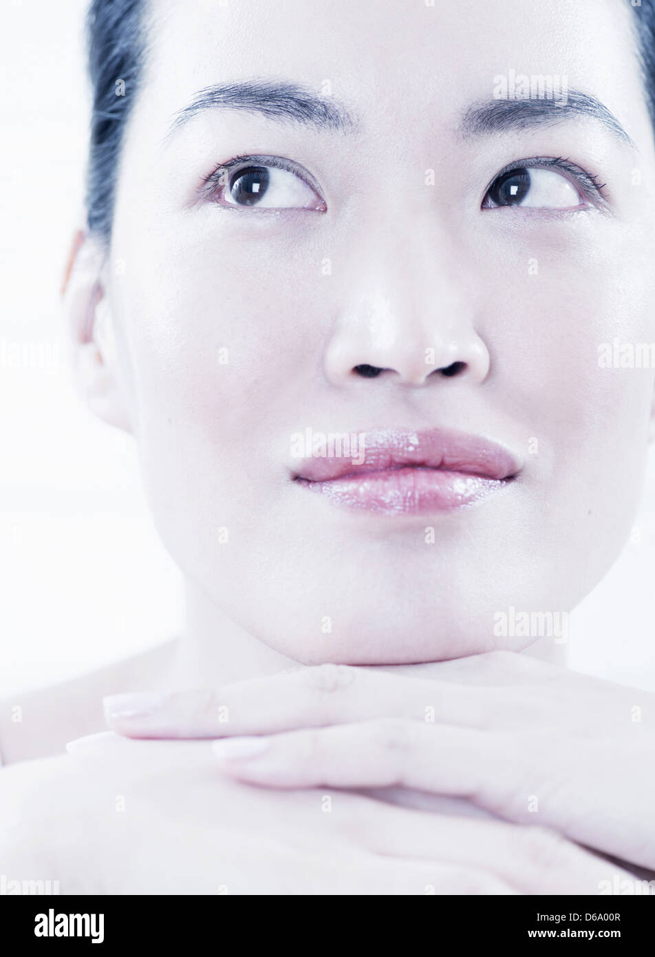 Close up of woman resting chin in hands Stock Photo