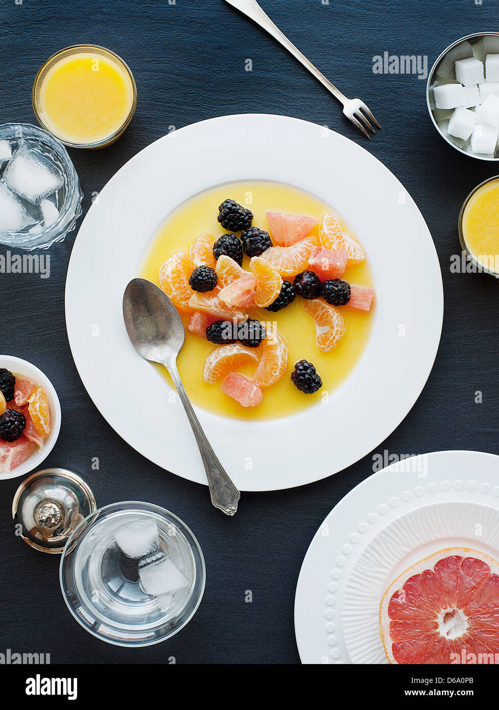 Plate of fruit with juice Stock Photo Alamy