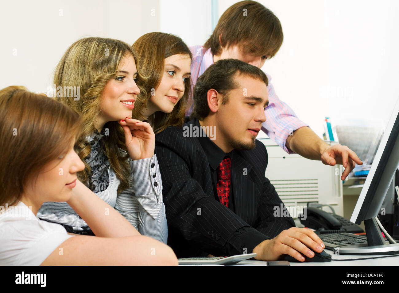 Young business people using computer Stock Photo - Alamy