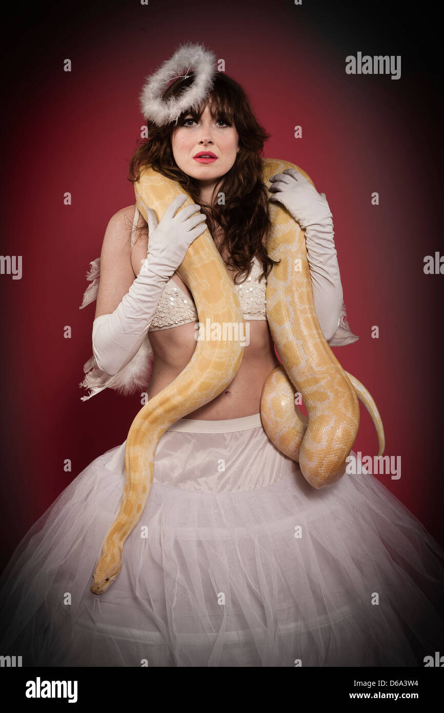 Woman in angel costume wearing snake Stock Photo