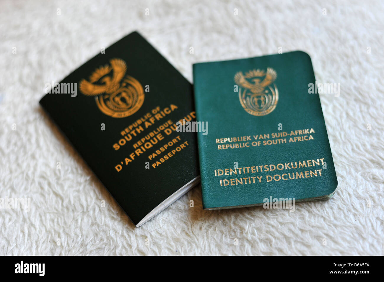 A new South African passport next to a South African Identity Document