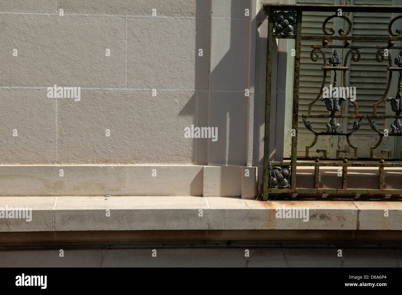 Close up of Classical window with green shutters and an ornate railing ...