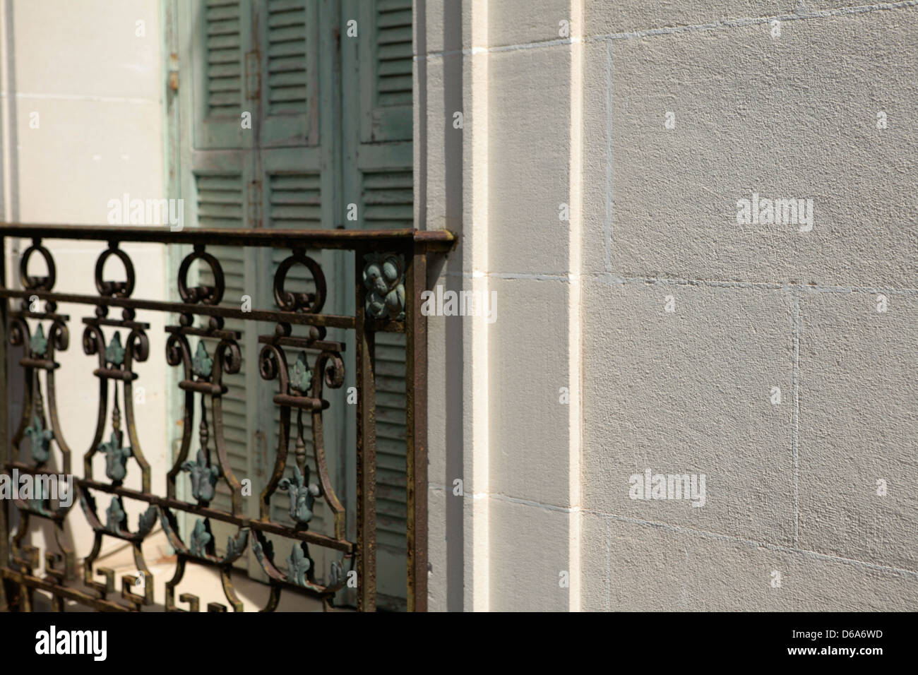 Close up of Classical window with green shutters and an ornate railing ...