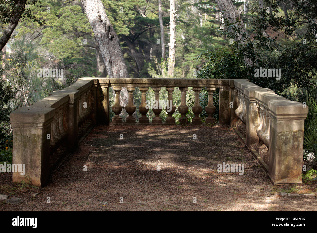Classic stone balustrade with trees in the background Stock Photo