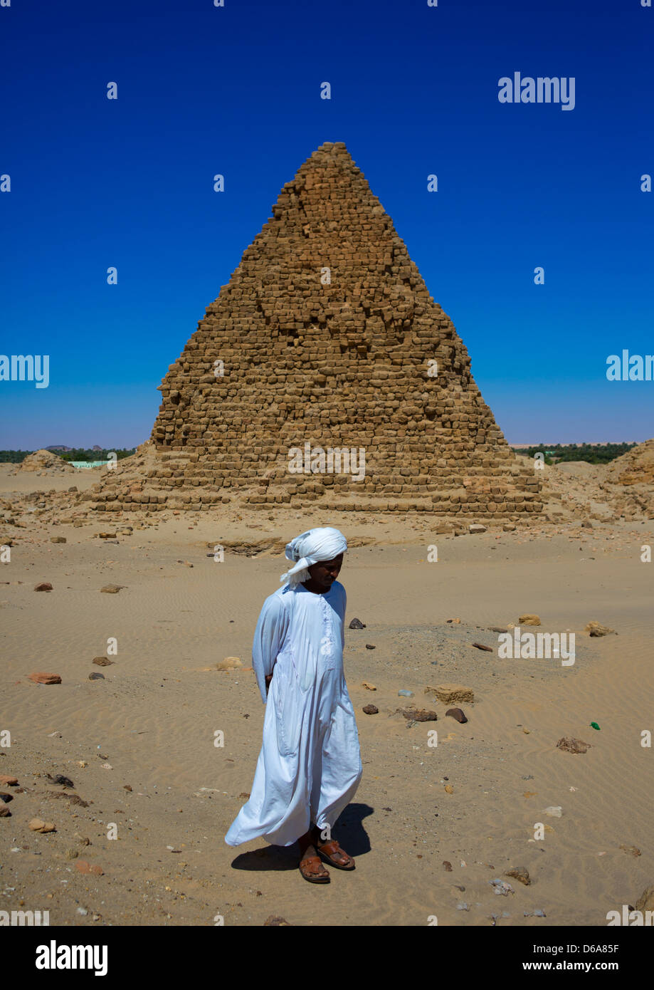 Sudanese Man In Front Of The Royal Pyramids Of Napata, Nuri, Sudan Stock Photo