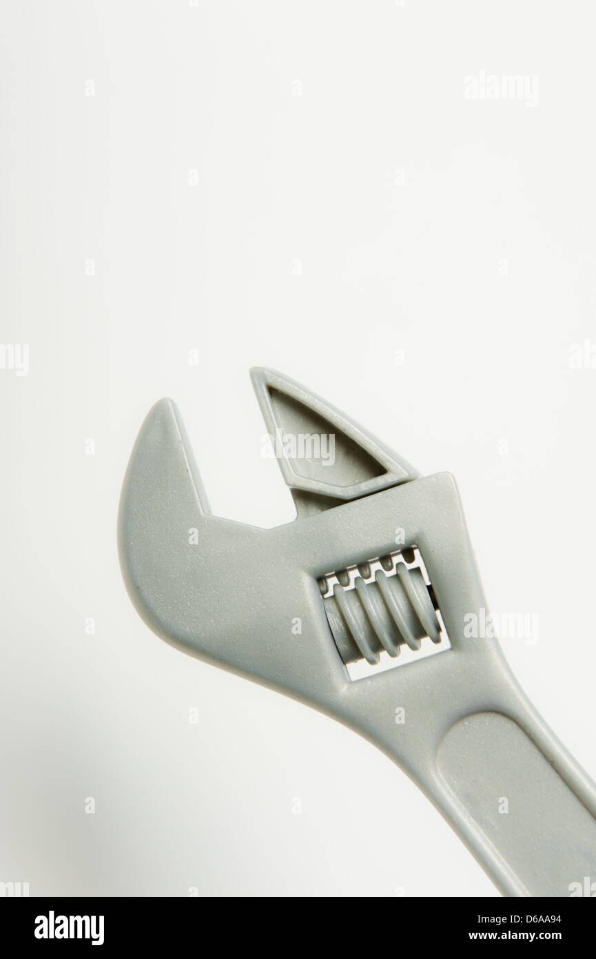 Plastic toy adjustable wrench against a plain background Stock Photo