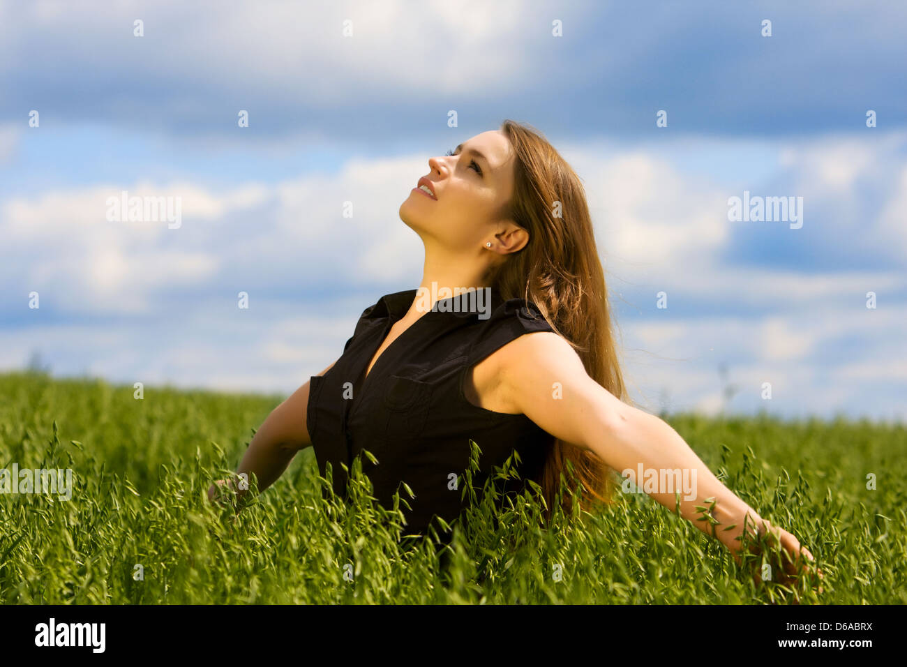 Happy young woman relaxing on nature Stock Photo - Alamy