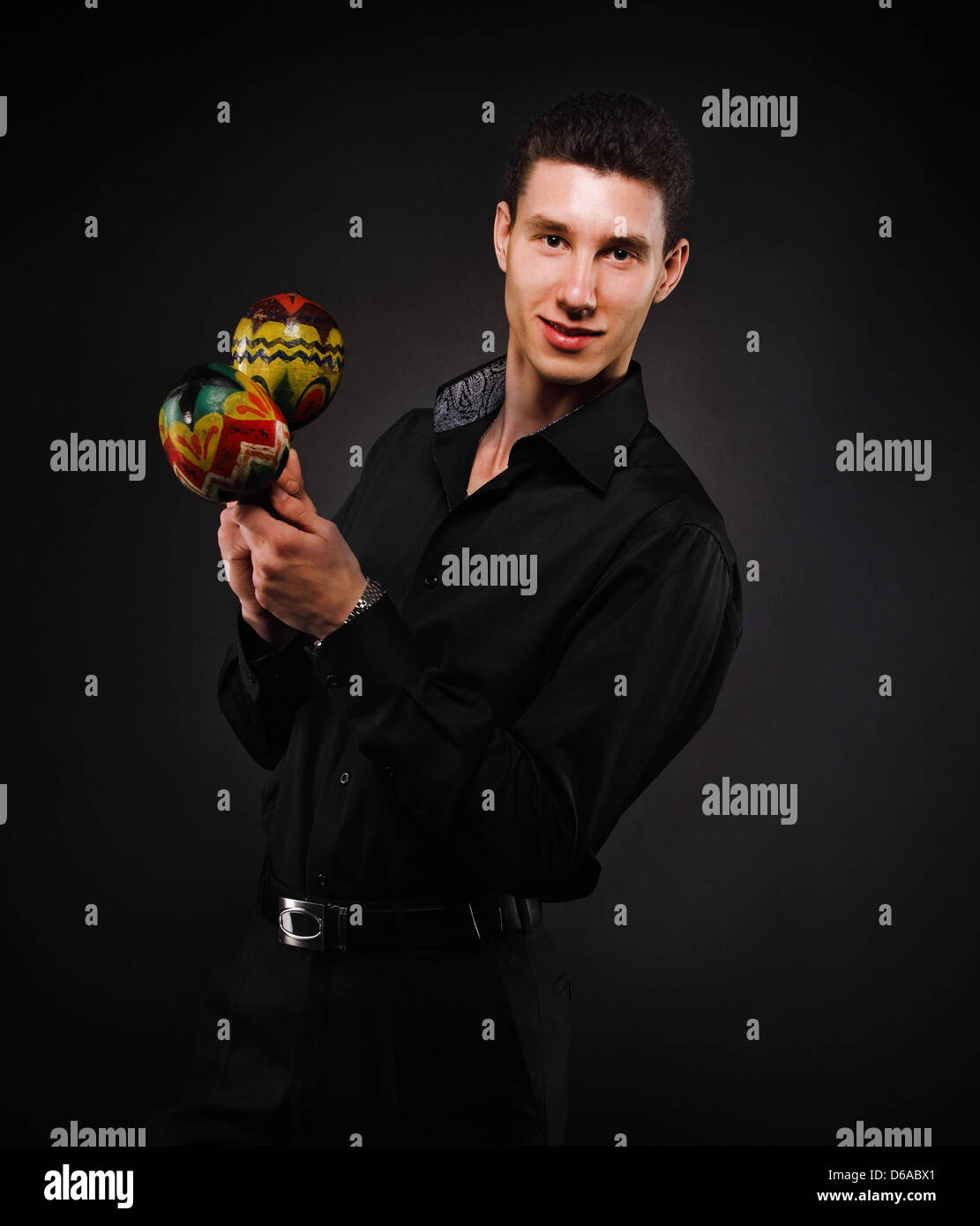 Handsome smiling man with maracas Stock Photo Alamy