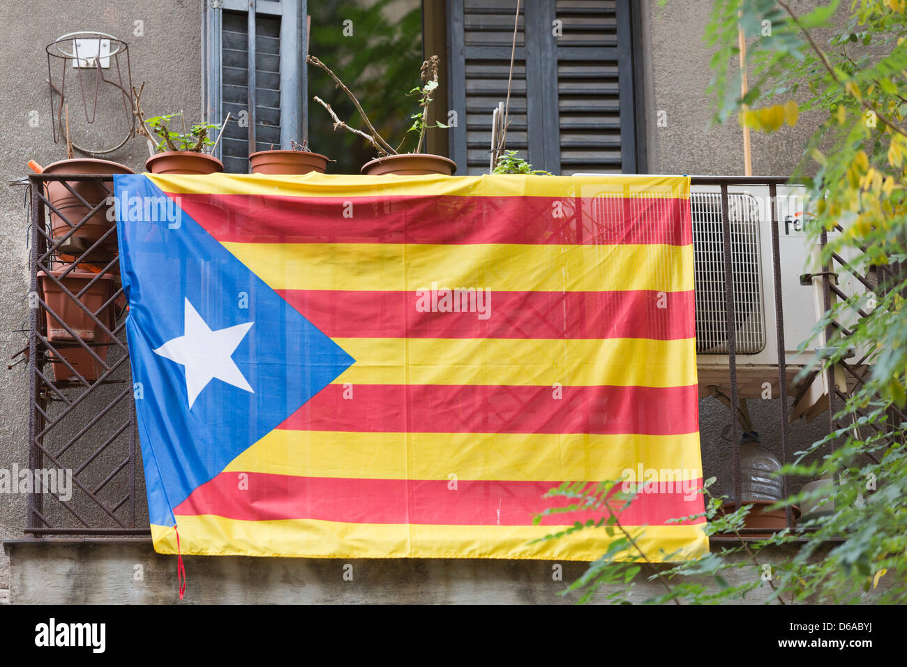 Flag of Catalonia, Catalunya, hanging from a balcony in Barcelona Stock Photo