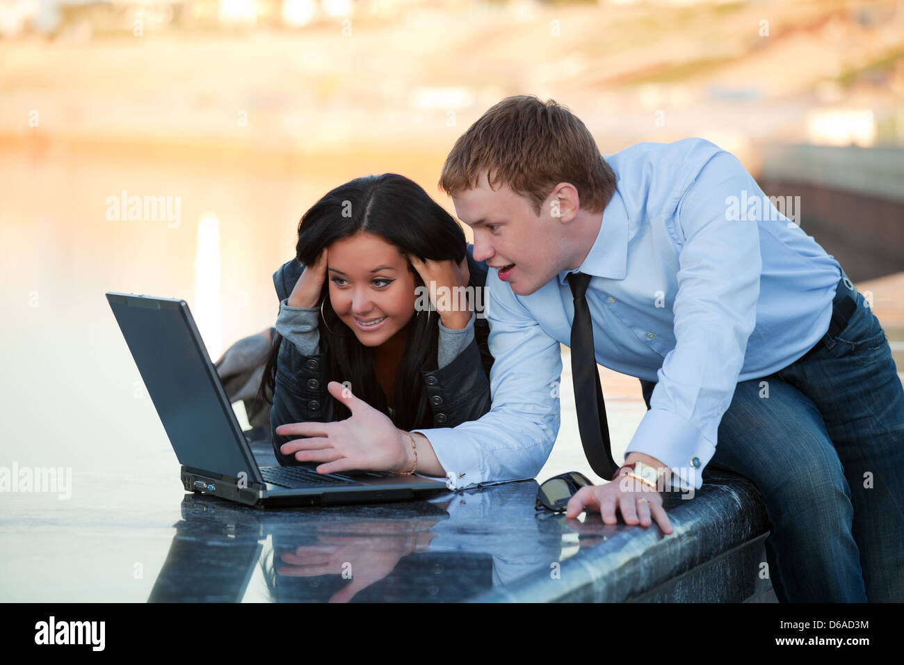 Young couple with laptop Stock Photo - Alamy