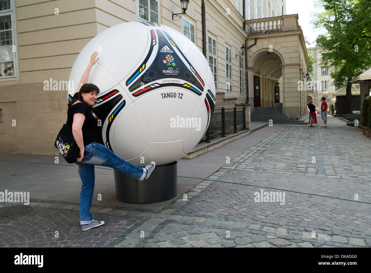 Lviv, Ukraine, young woman posing in front of a oversized model of the  adidas Tango 12 Stock Photo - Alamy