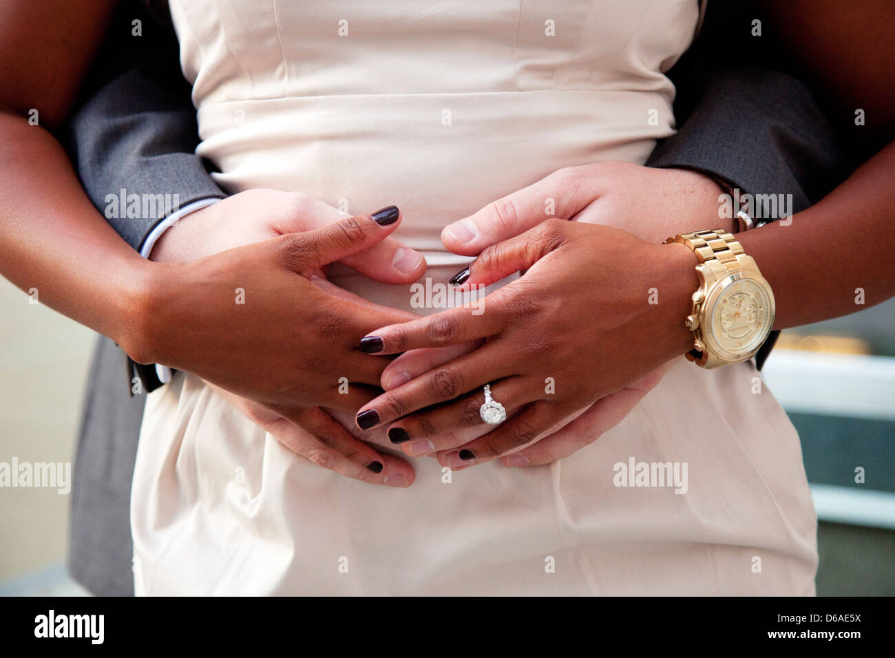 Couple's Hands Touching at Waist Stock Photo