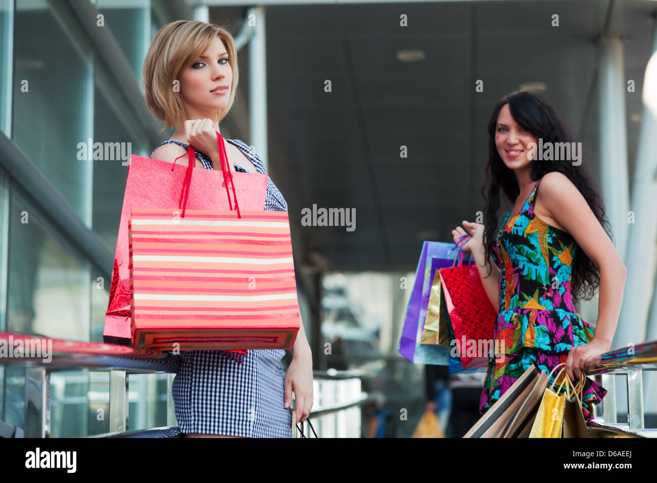 Two young women with shopping bags Stock Photo - Alamy
