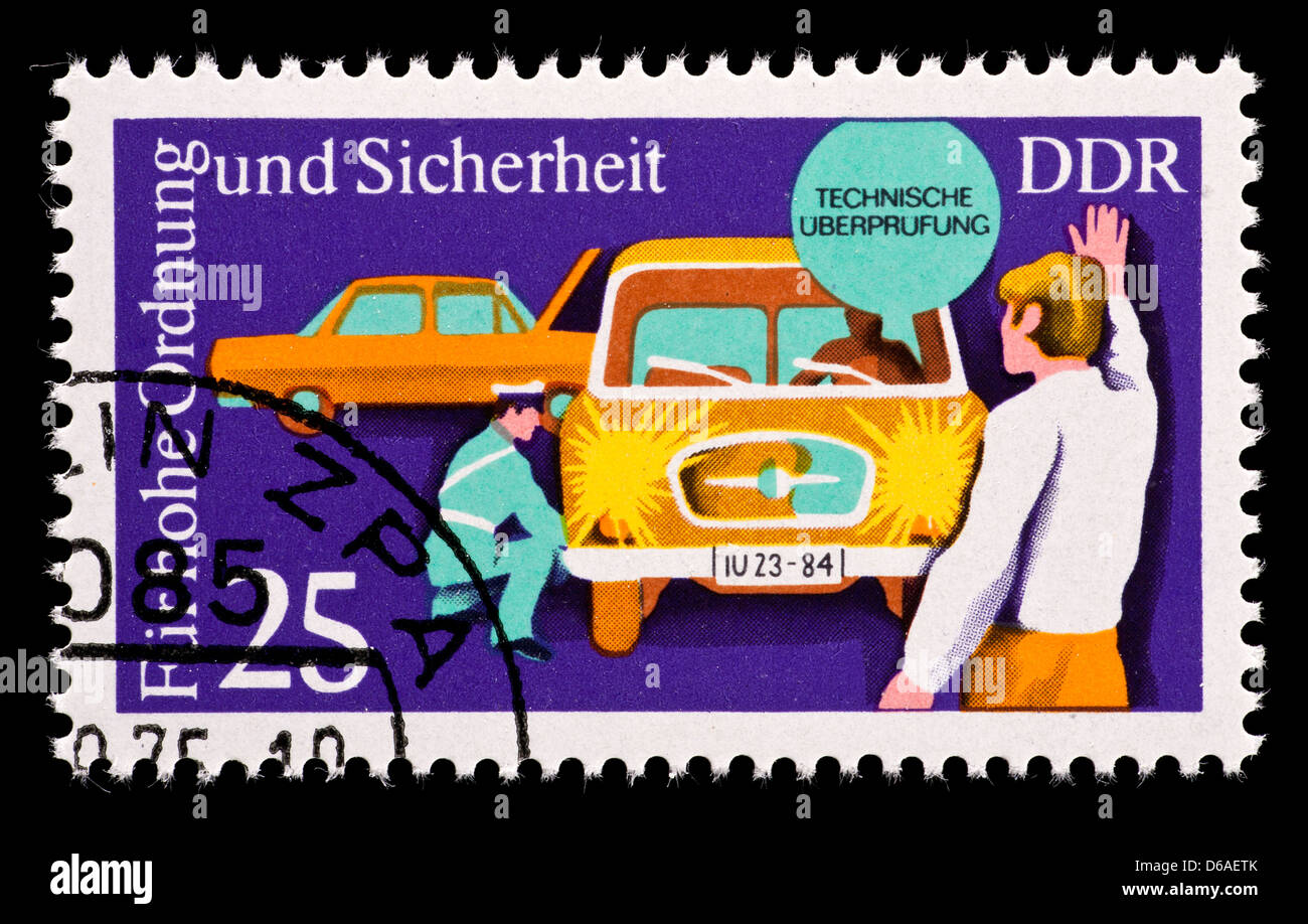 Postage stamp from East Germany (DDR) depicting a man conducting a safety inspection of a vehicle. Stock Photo