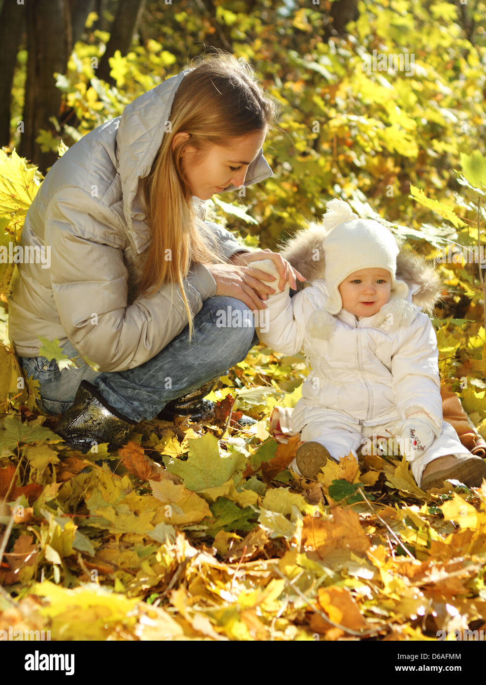Mother with little daughter in autumn park Stock Photo - Alamy