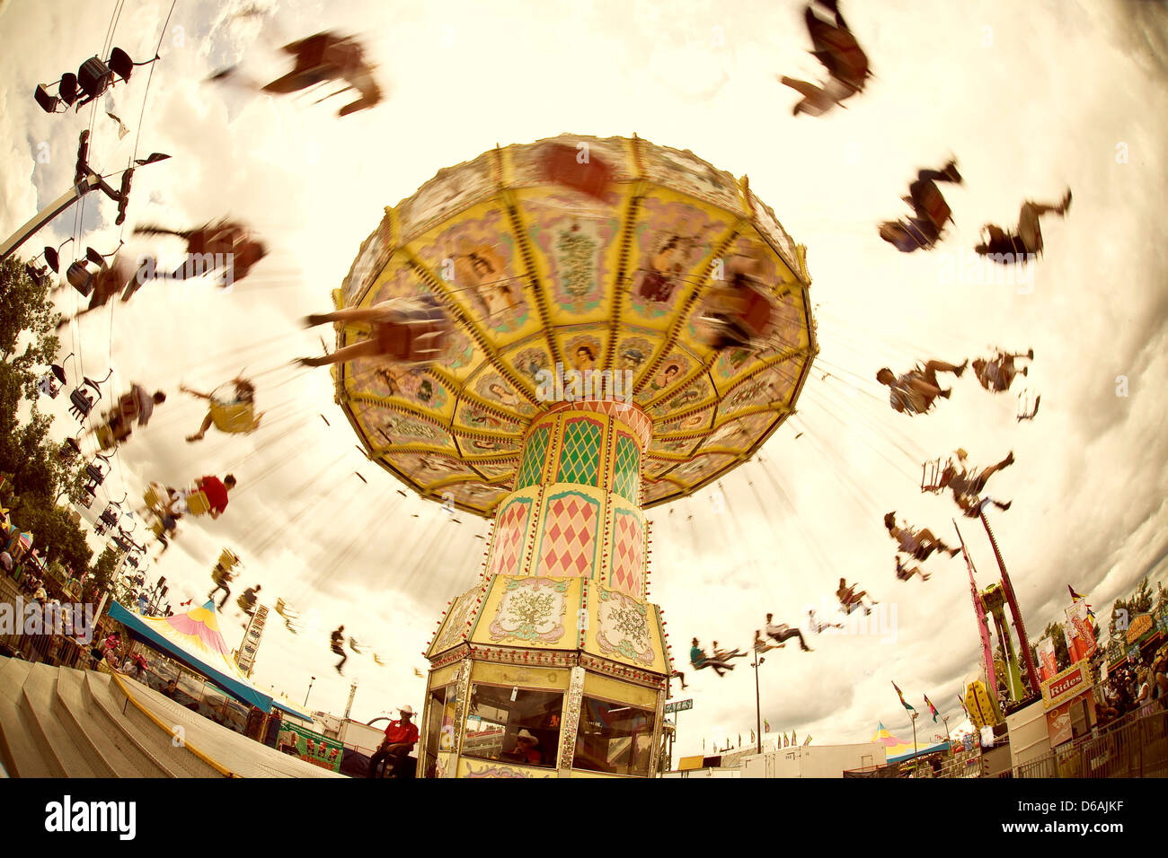 Chain swing amusement ride in motion, people flying overhead. Fun at