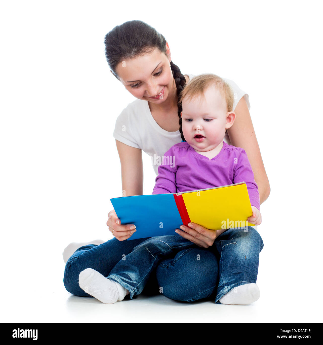 happy mother reading a book to child girl Stock Photo