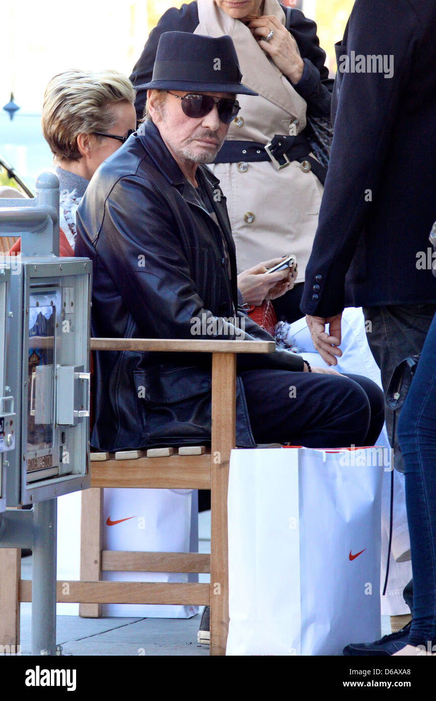 Johnny Hallyday Sitting On A Bench As He Leaves A Restaurant After