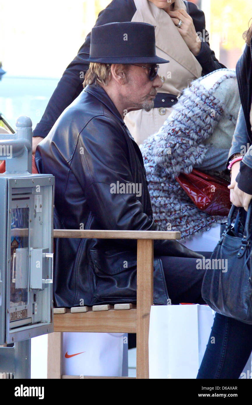 Johnny Hallyday Sitting On A Bench As He Leaves A Restaurant After