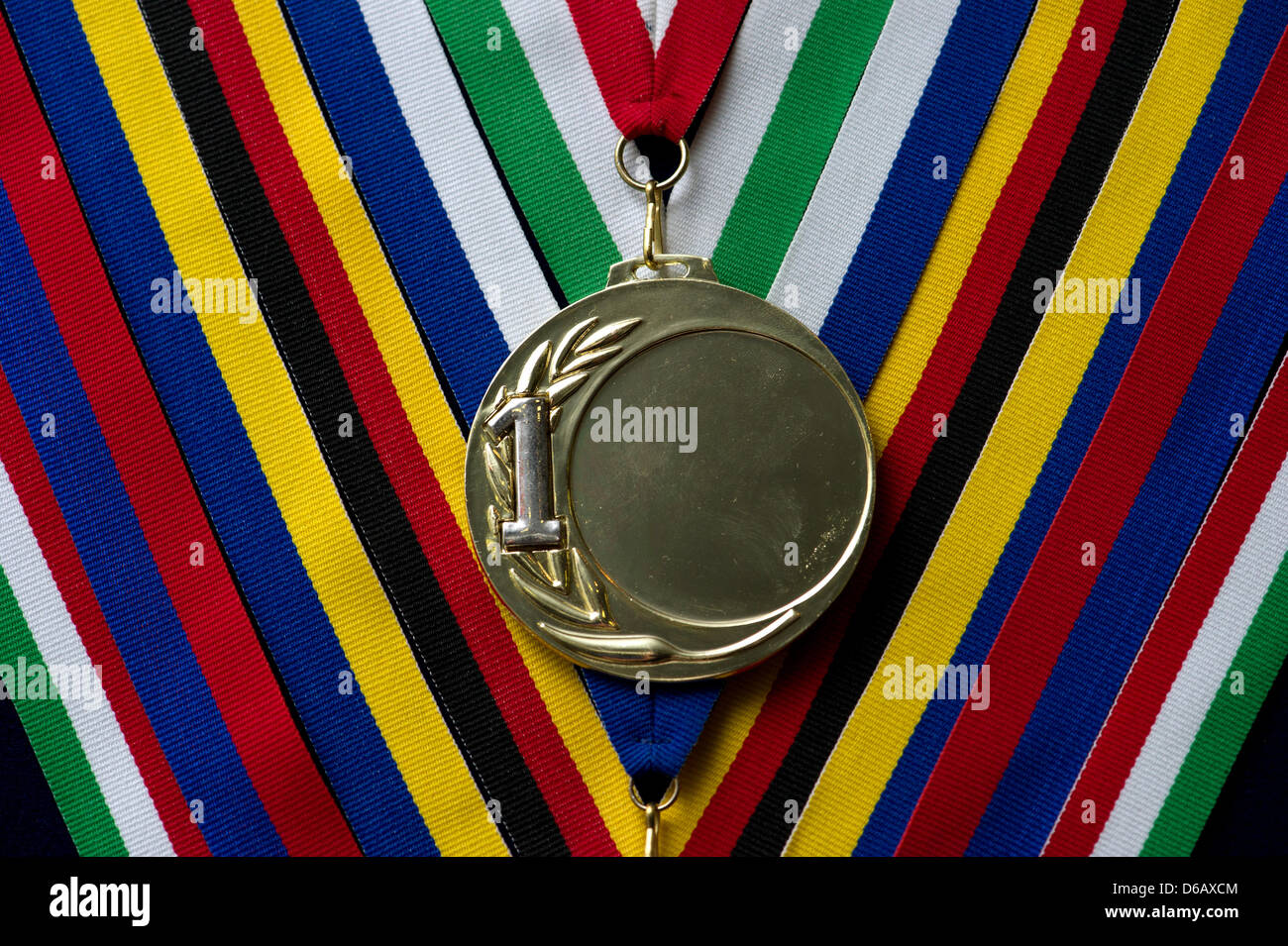 A blank medal made from gold-colored material with 1 printed on it lies on a table in Berlin, Germany, 07 August 2012. Photo: Soeren Stache Stock Photo