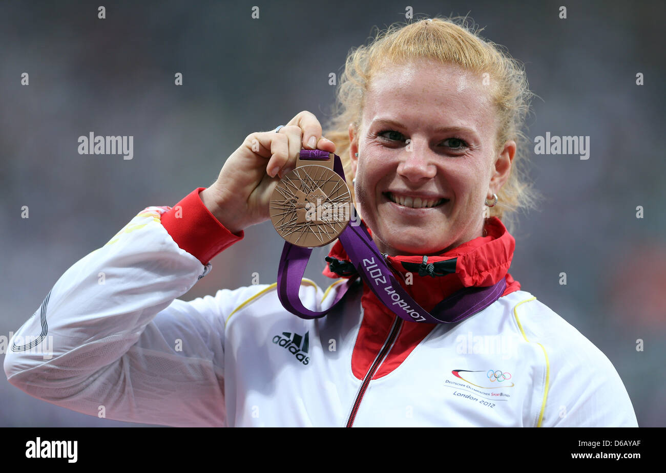 Bronze medalist Betty Heidler of Germany smiles during the medal