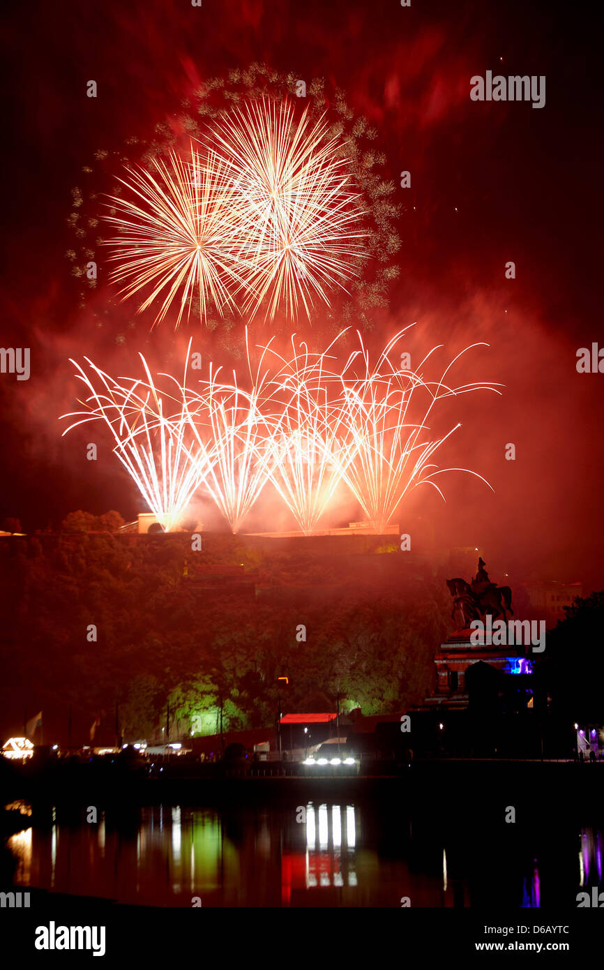 Fireworks are seen above the illuminated Ehrenbreitstein castle at the end of the 'Rhein in Flammen' (Rhine in Flames) event in Koblenz, Germany, 11 August 2012. In the front, the William I monument at the German Corner (Deutsches Eck) is seen. Photo: Thomas Frey Stock Photo