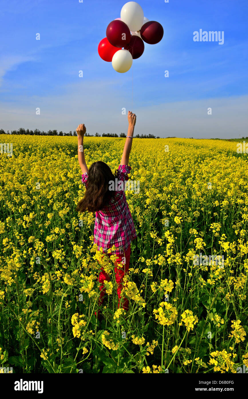young girl playing with balloons Stock Photo