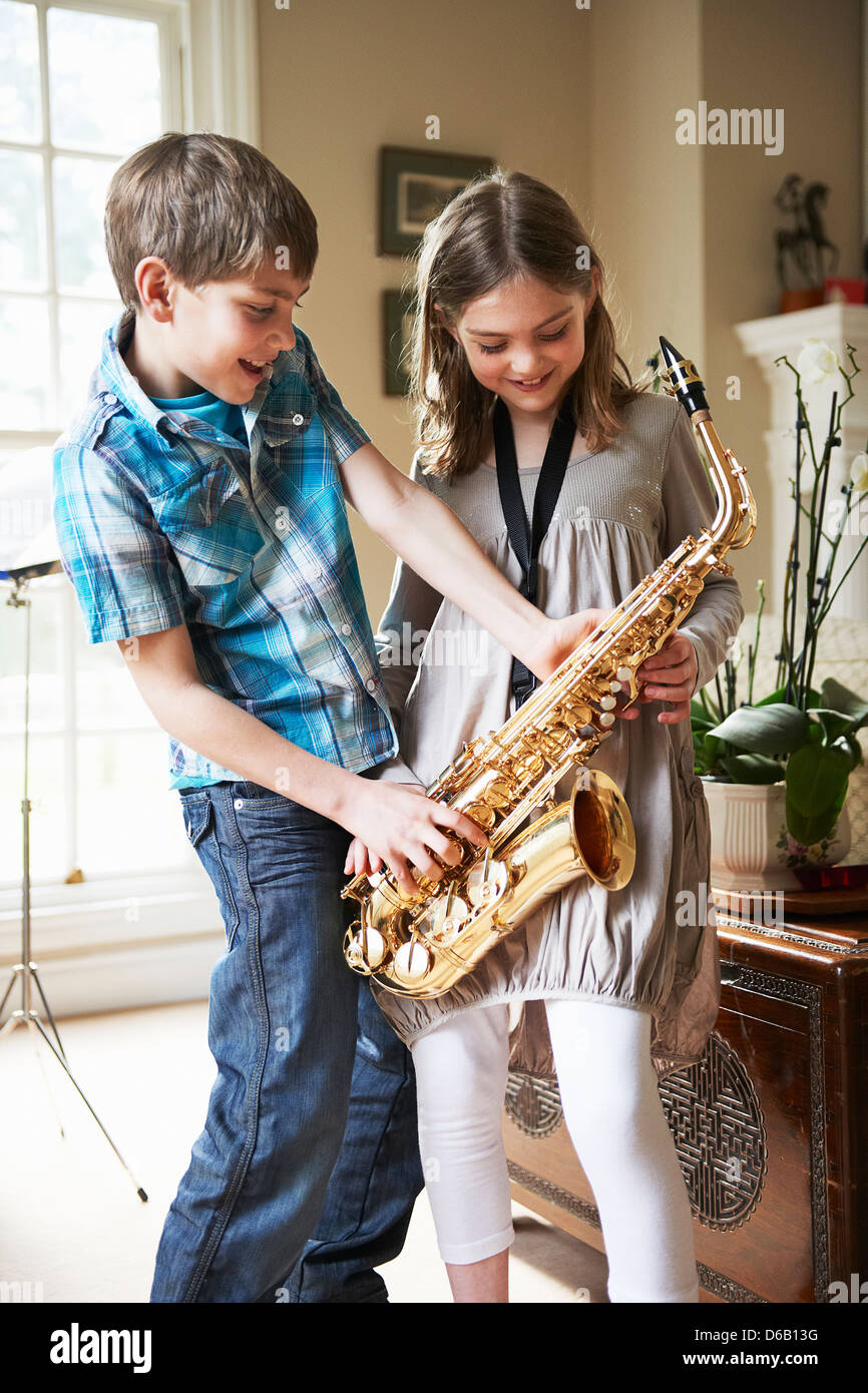 Children playing with saxophone Stock Photo