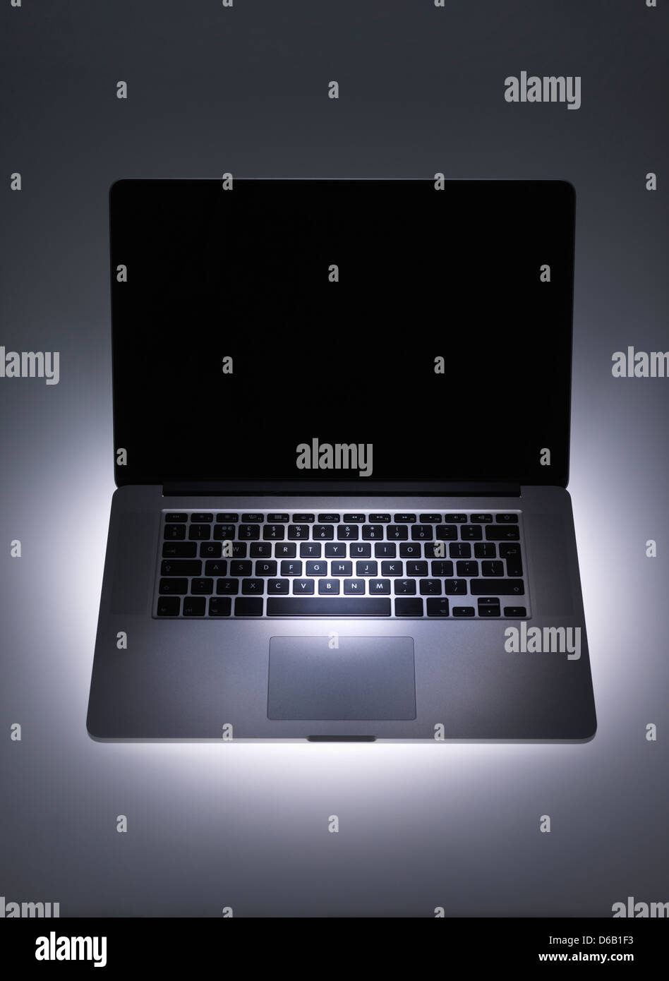 Spotlight on laptop computer Stock Photo - Alamy