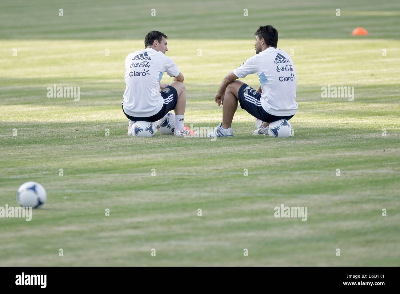 Argentine player Lionel Messi (L) talks to teammate Sergio 'Kun' Aguero during a practice session of the Argentine national soccer squad at the Sportpark soccer stadium in Neu-Isenburg, Germany, 13 August 2012. The Argentine  soccer squad is preparing for the international soccer match against Germany which is due to take place in the Commerzbank-Arena soccer stadium in Frankfurt o Stock Photo