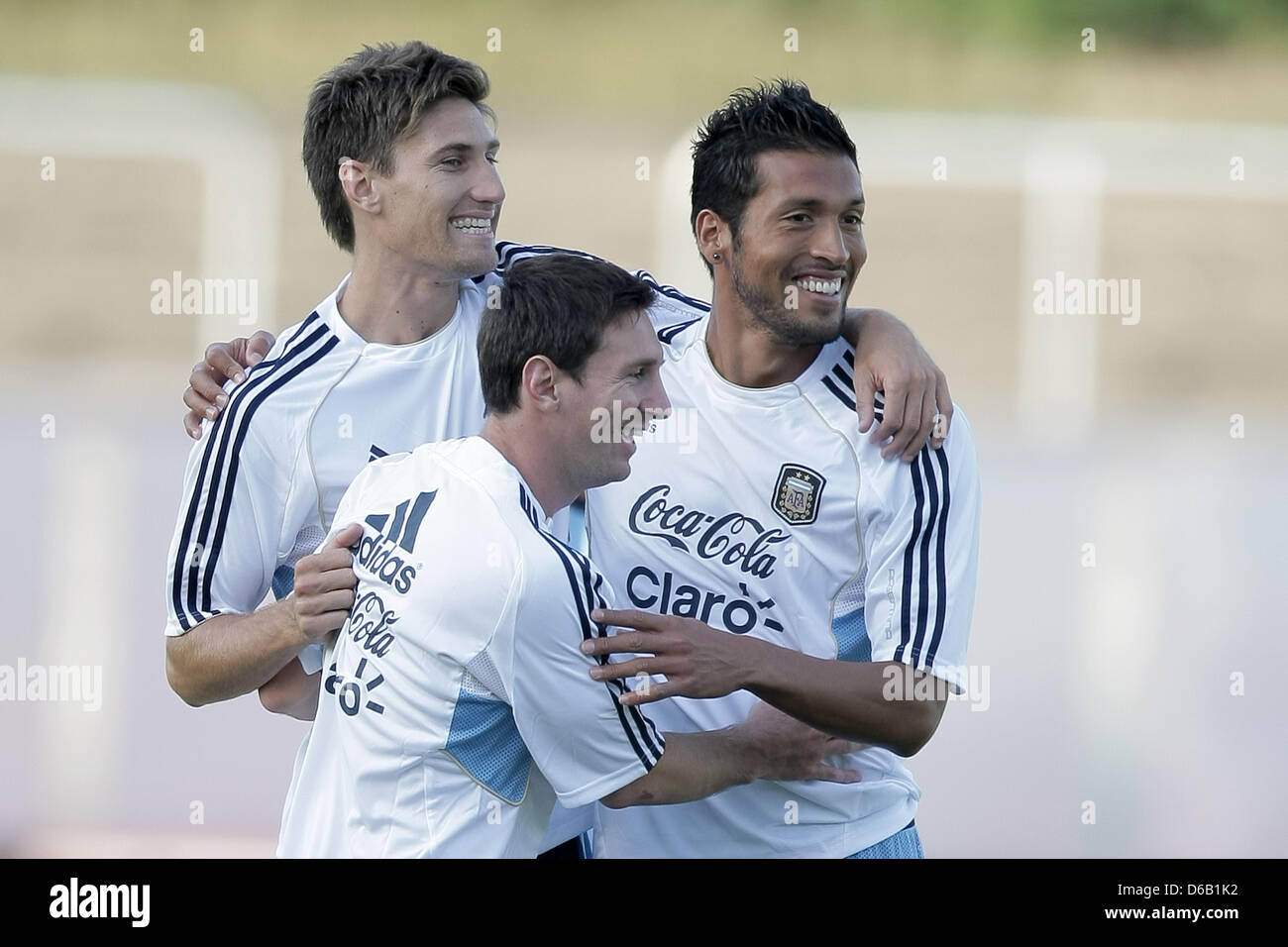 Argentine player Lionel Messi (C) jokes with Ezequiel Garay (R) and Federico Fernandez (L) during a practice session of the Argentine national soccer squad at the Sportpark soccer stadium in Neu-Isenburg, Germany, 13 August 2012. The Argentine  soccer squad is preparing for the international soccer match against Germany which is due to take place in the Commerzbank-Arena soccer sta Stock Photo