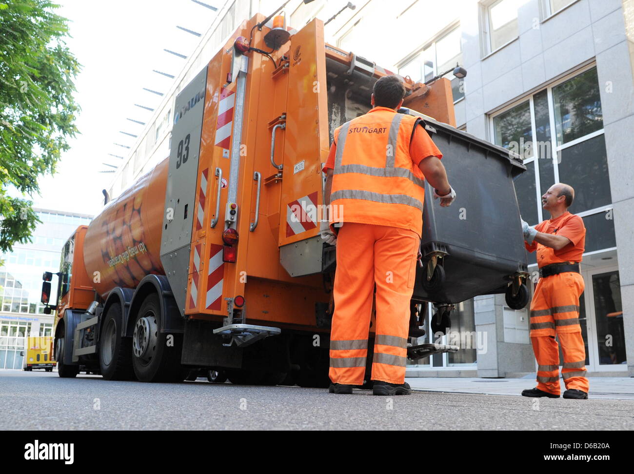 Stuttgart waste management workers load a garbage truck in Stuttgart