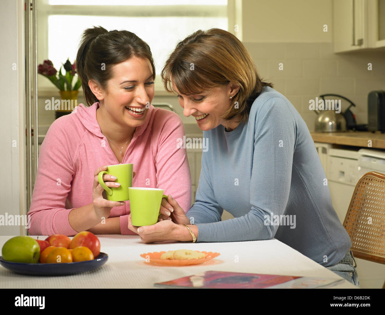 Women having coffee together in kitchen Stock Photo
