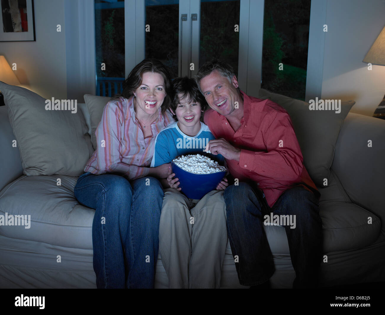 Family watching movie together Stock Photo