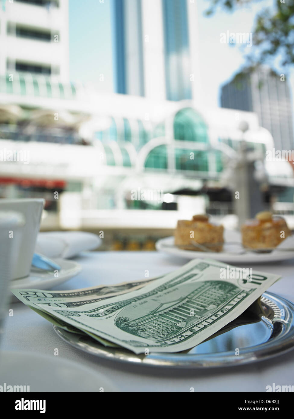 Money in tray on restaurant table Stock Photo Alamy