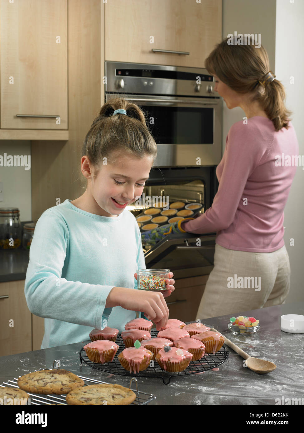 Mother and daughter baking together Stock Photo