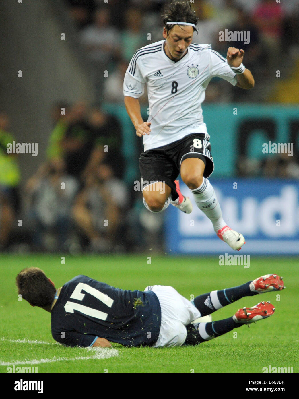 Germany's  Mesut Ozil jumps over Argentina's Federico Fernandez during the friendly soccer match between Germany and Argentina at the Commerzbank-Arena in Frankfurt/Main, Germany, 15 August 2012. Photo: Arne Dedert Stock Photo