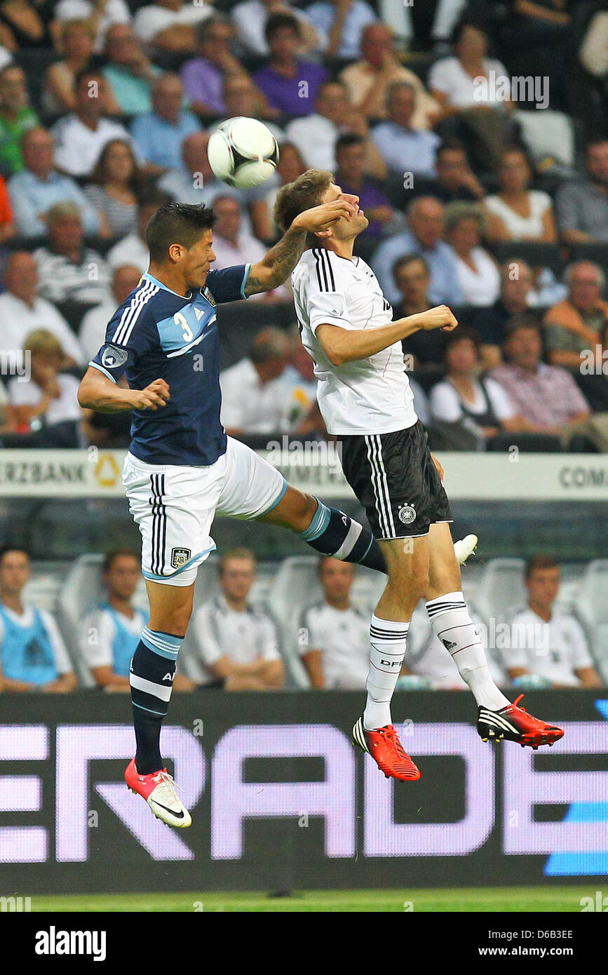 Germany's Thomas Mueller (R) vies for the ball with Argentina's Marcos Rojo during the friendly soccer match between Germany and Argentina at the Commerzbank-Arena in Frankfurt/Main, Germany, 15 August 2012. Photo: Revierfoto Stock Photo