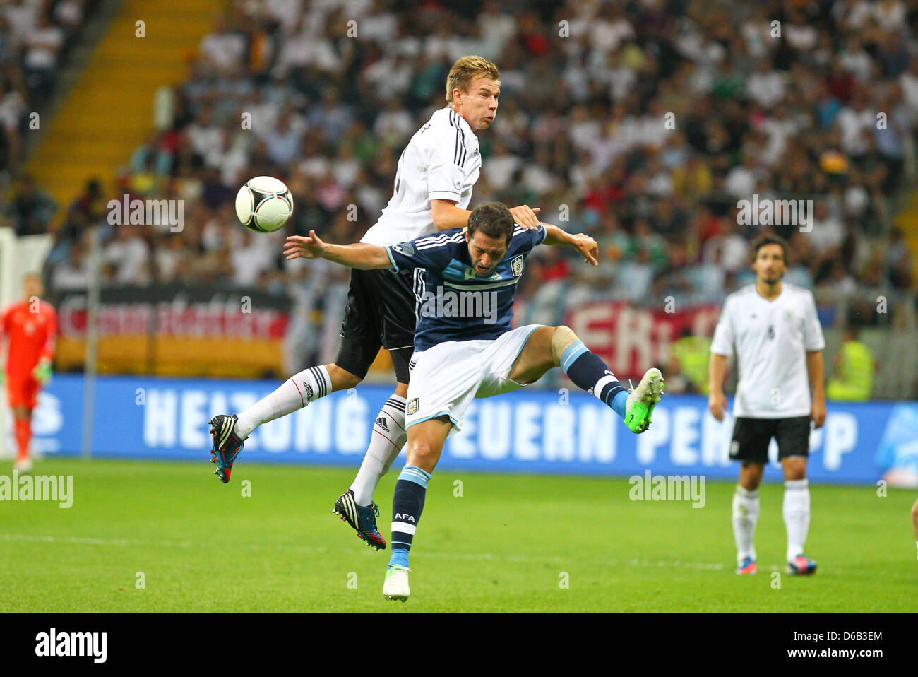 Germany's Holger Badstuber (top) vies for the ball with Argentina's Gonzalo Higuain during the friendly soccer match between Germany and Argentina at the Commerzbank-Arena in Frankfurt/Main, Germany, 15 August 2012. Photo: Revierfoto Stock Photo