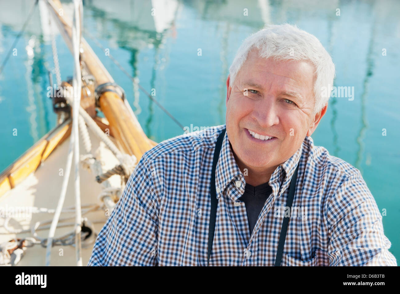 Older man sitting on boat Stock Photo