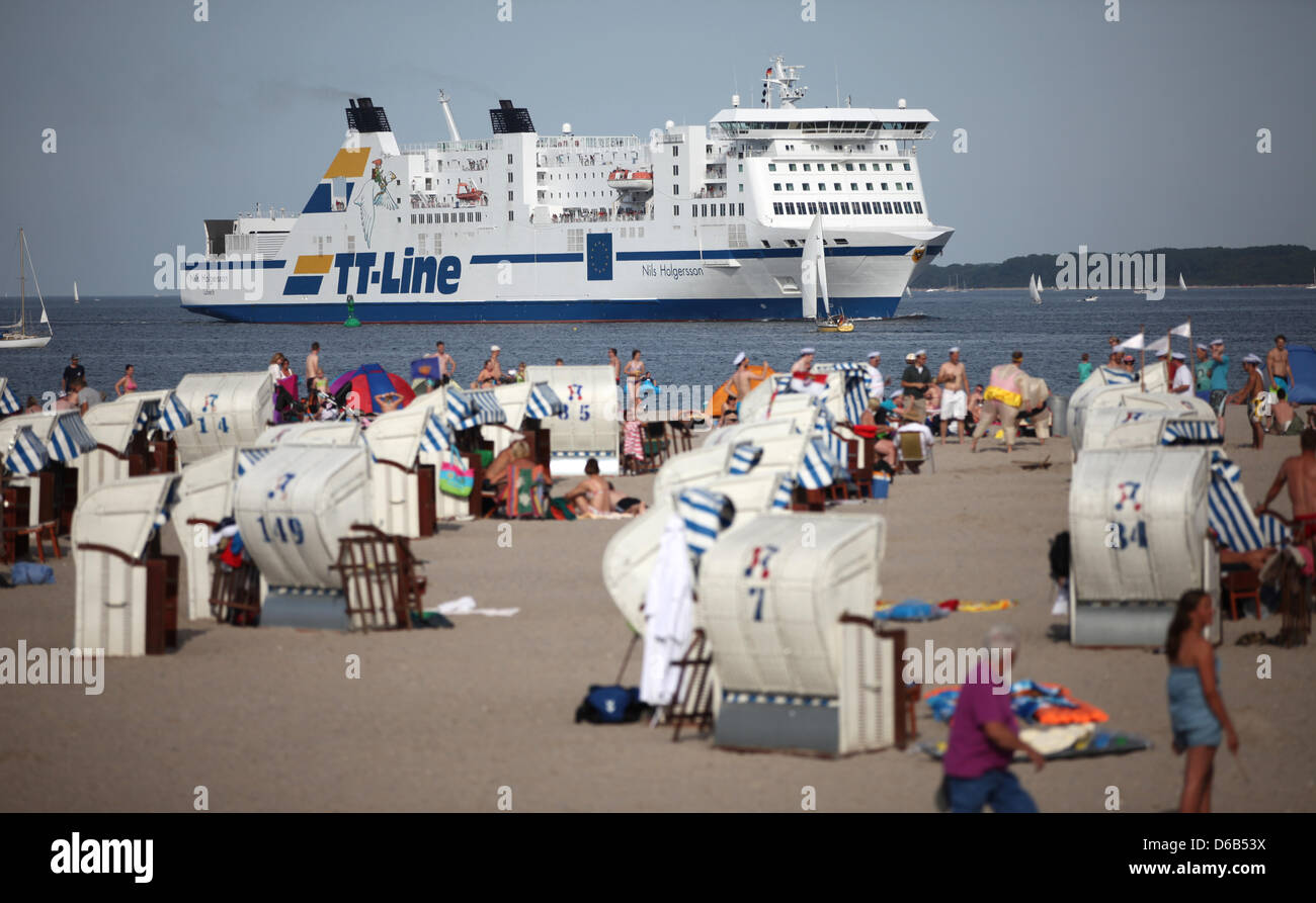 The TT-Line ferry 'Nils Holgersson' goes past bathers at the beach of Travemuende near Luebeck, Germany, 18 August 2012. Meteorologists predict record summer temperatures in Germany for the weekend. Photo: CHRISTIAN CHARISIUS Stock Photo