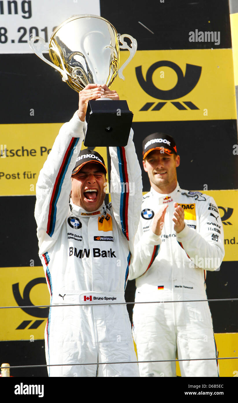 Canadian racing driver Bruno Spengler of BMW celebrates his victory of the 6th race of the German Touring Car Masters (DTM) with the trophy at the Nuerburgring, Gerrmany, 19 August 2012. Photo: JUERGEN TAP Stock Photo