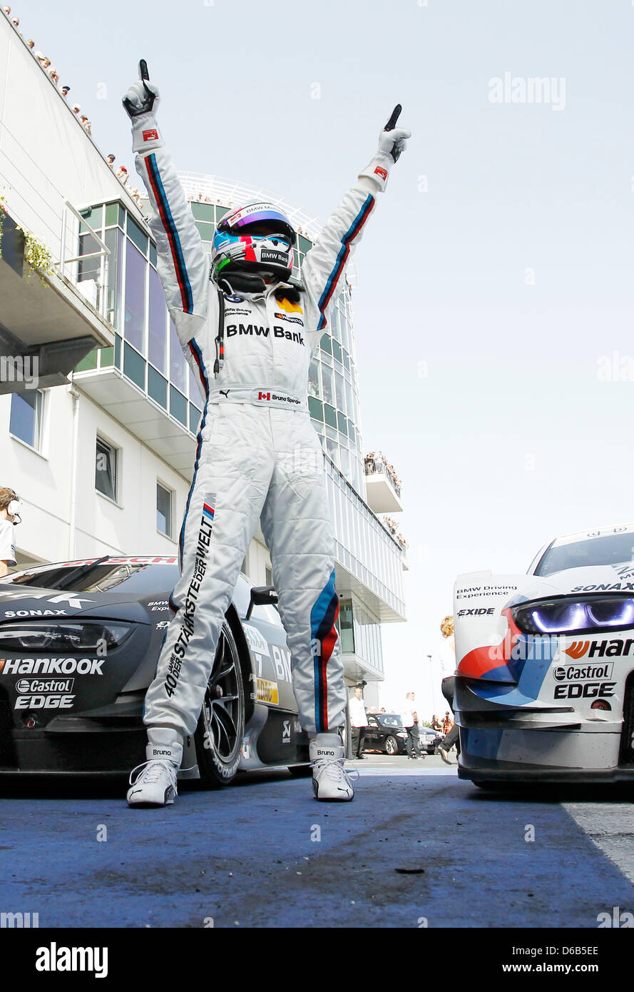 Canadian racing driver Bruno Spengler of BMW celebrates his victory of the 6th race of the German Touring Car Masters (DTM) in the parc fermee at the Nuerburgring, Gerrmany, 19 August 2012. Photo: JUERGEN TAP Stock Photo