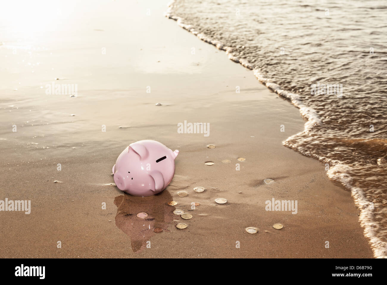 Piggy bank washed up on beach Stock Photo