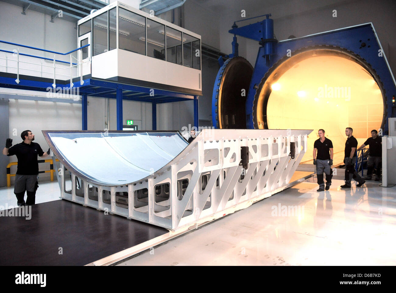 DLR employees take the finished hardened CFK parts from the world's